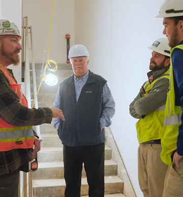 a group of workers consulting on controls placement